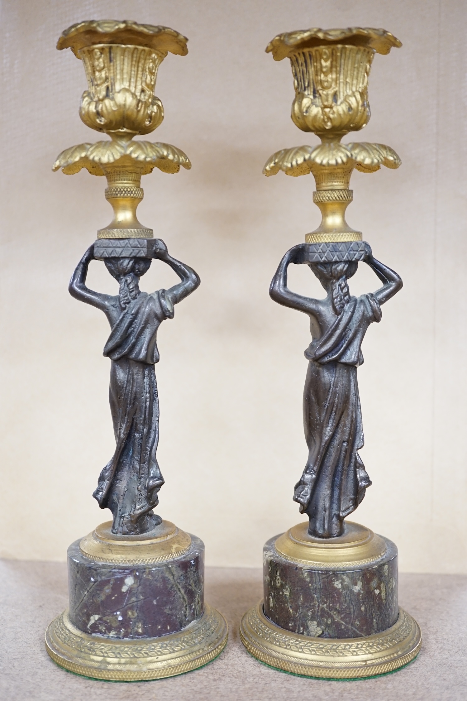 A pair of Regency style bronze and ormolu figural candlesticks on serpentine plinths, 22.5cm. Condition - fair to good